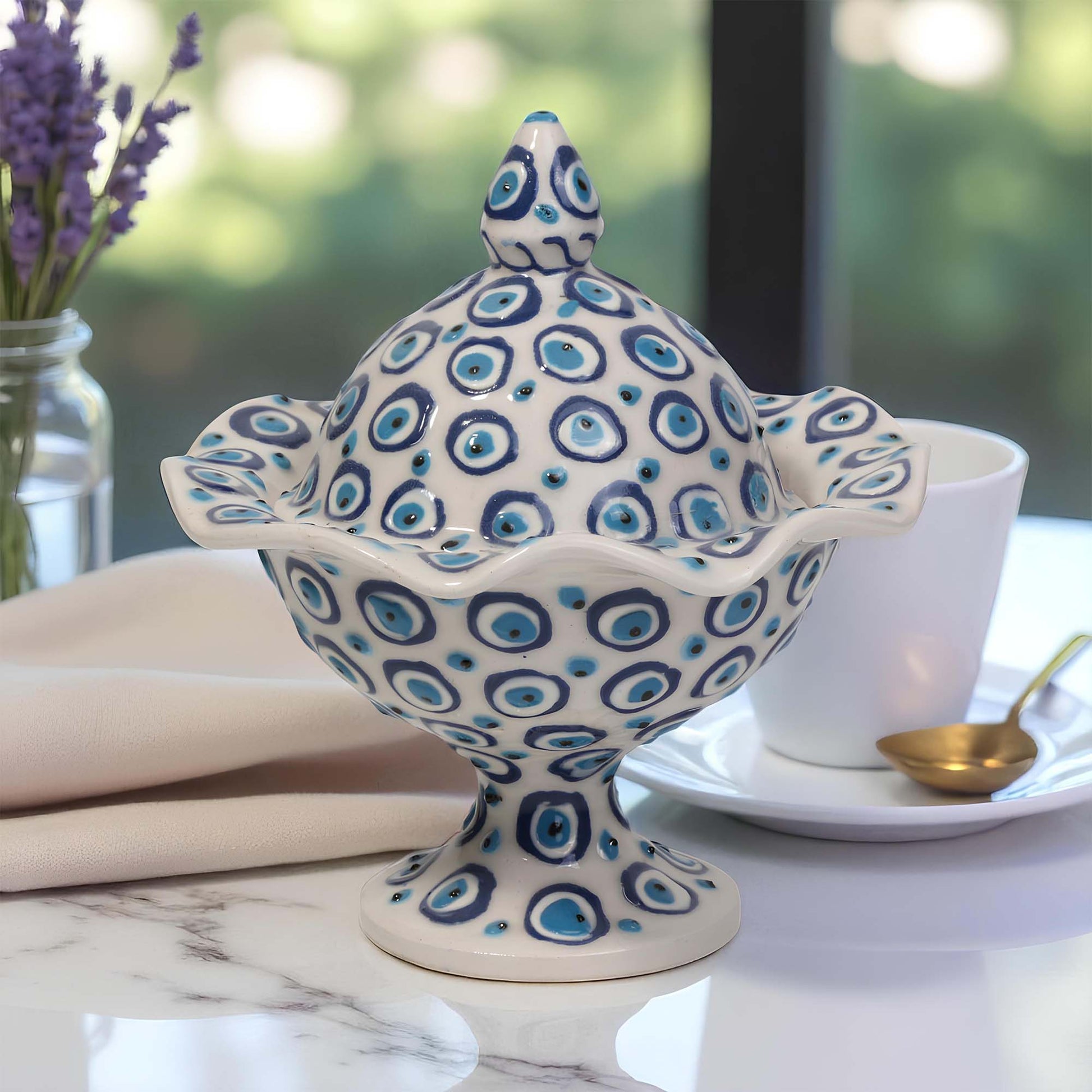 Decorative ceramic sugar bowl with blue and white pattern on a table setting.