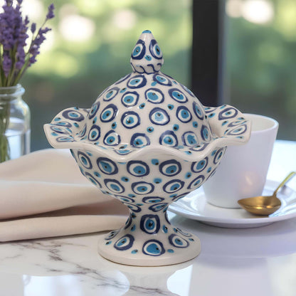 Decorative ceramic sugar bowl with blue and white pattern on a table setting.