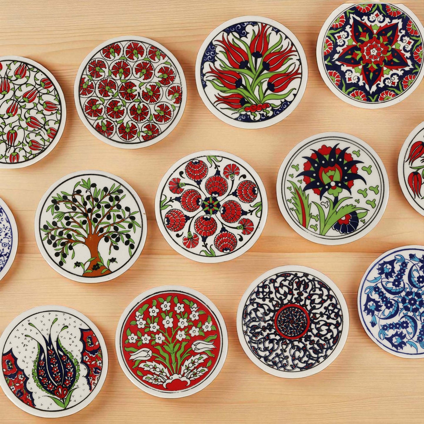 Collection of decorative ceramic coasters with intricate patterns on a wooden surface