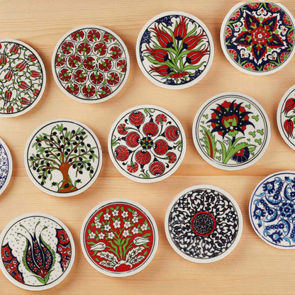Collection of decorative ceramic coasters with intricate patterns on a wooden surface