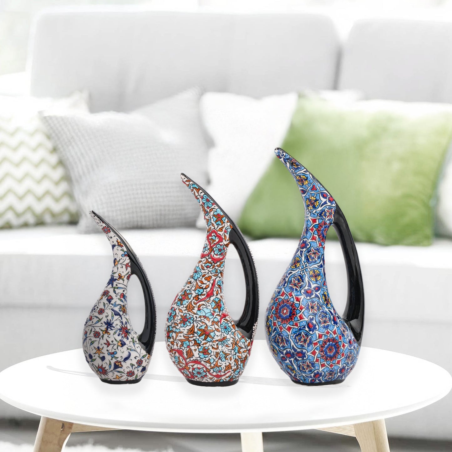 Set of 3 hand-painted ceramic ewers with Ottoman floral motifs in unique color palettes. Glossy artisan pieces with black handles, perfect décor or gifts.