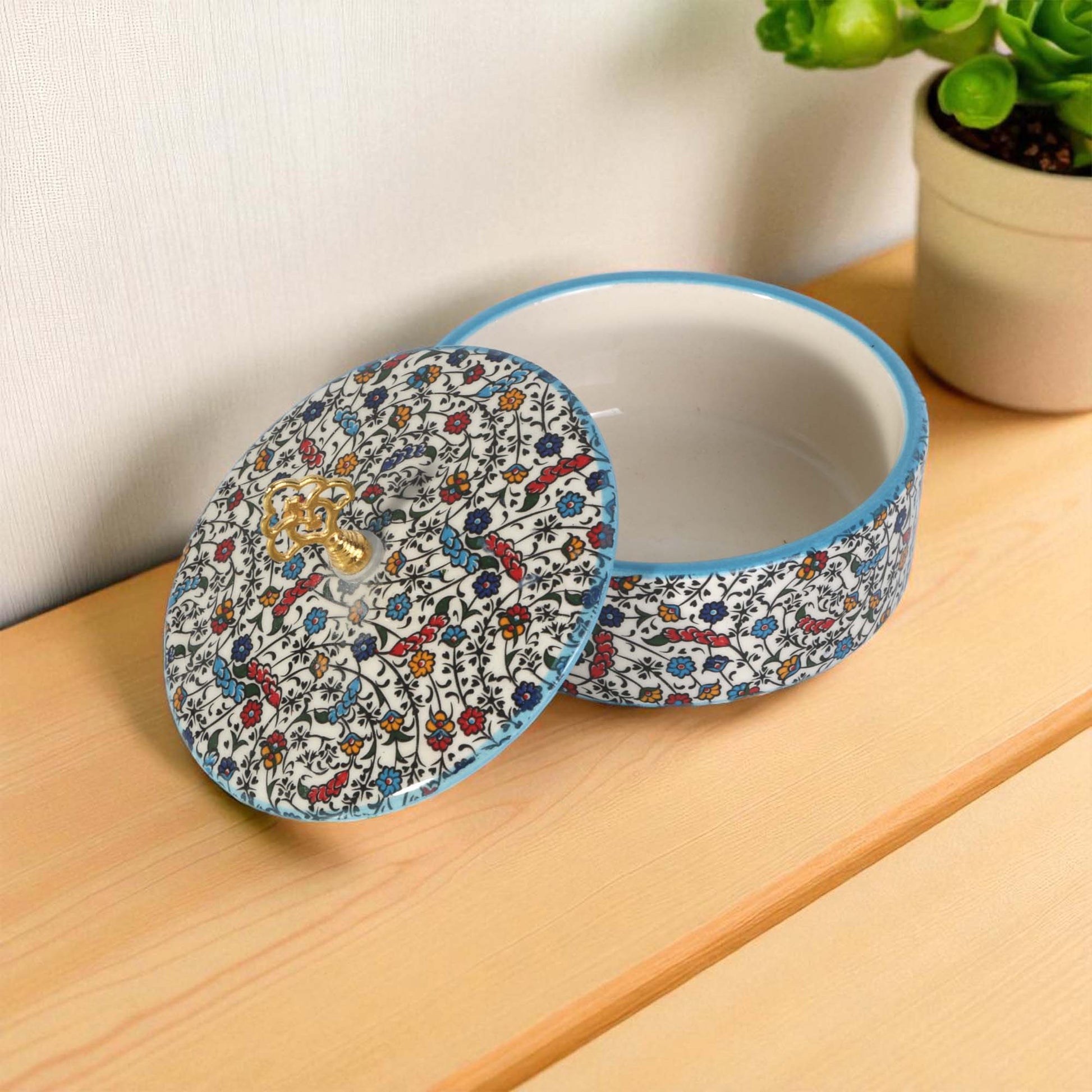 Ceramic sugar bowl with a patterned lid on a wooden surface