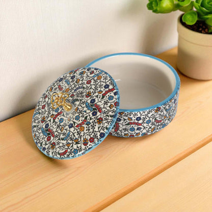 Ceramic sugar bowl with a patterned lid on a wooden surface