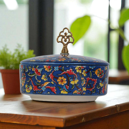 Decorative ceramic sugar bowl with floral patterns on a wooden surface