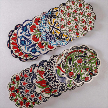 Set of colorful ceramic coasters with intricate patterns on a white background