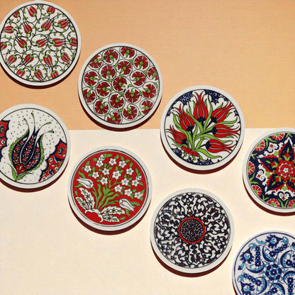 Set of ceramic coasters with intricate floral and geometric designs on a beige background