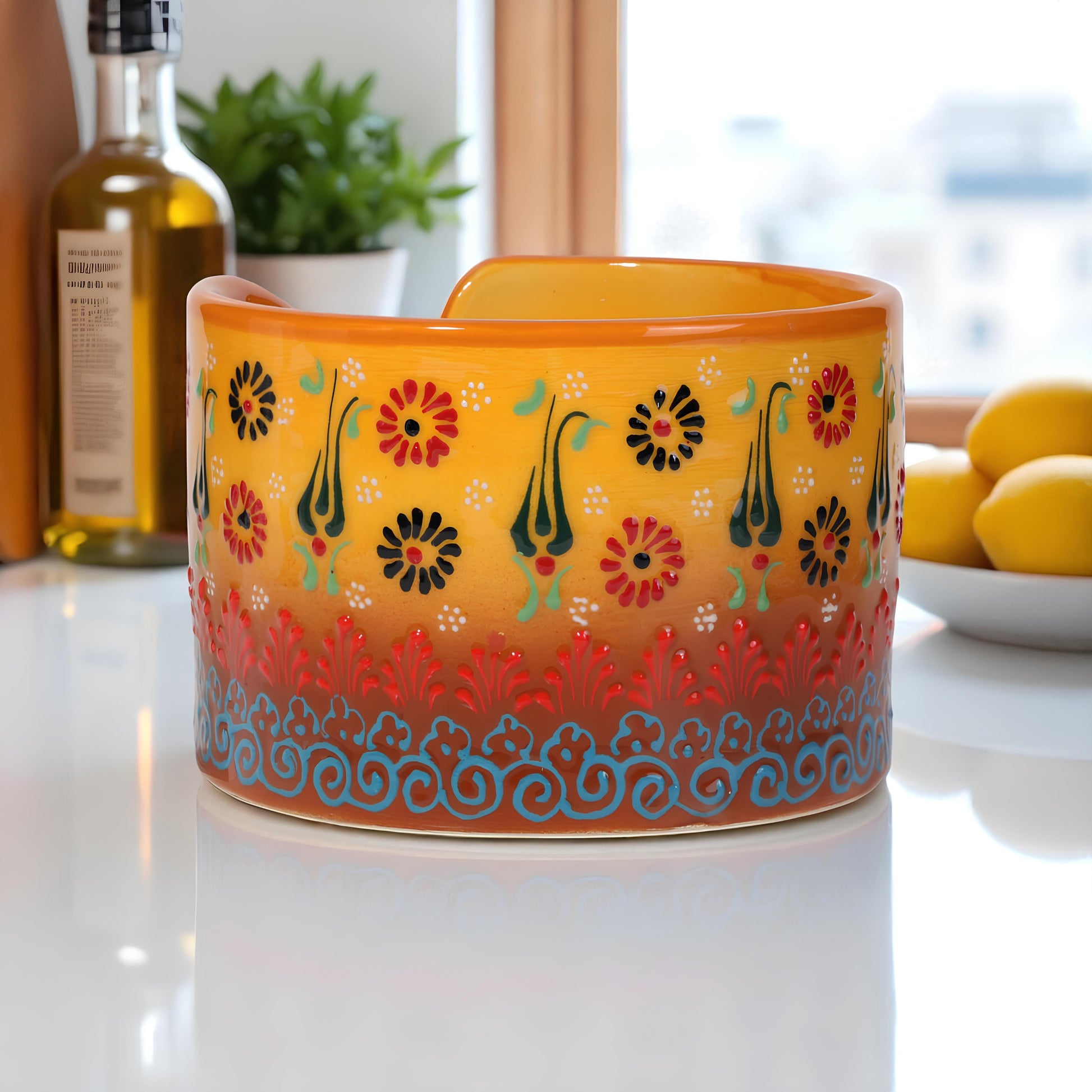 Decorative ceramic paper towel holder with floral patterns on a kitchen counter