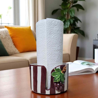 Roll of paper towels in a decorative paper towel holder on a table with a living room background