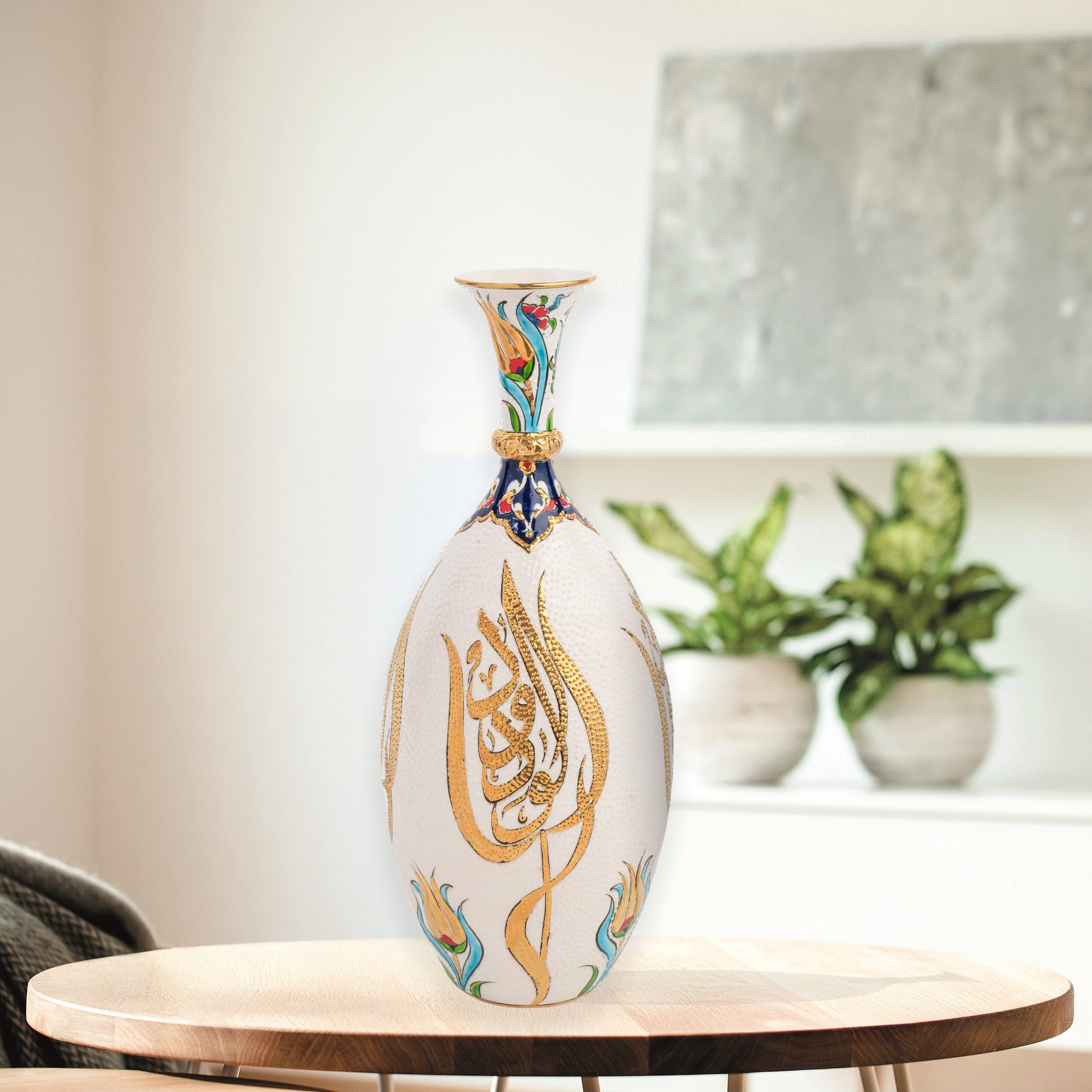 Hand-painted ceramic decorative bottle with golden Arabic calligraphy on ivory, accented with floral motifs. Glossy artisan vase, perfect for décor or gifts.