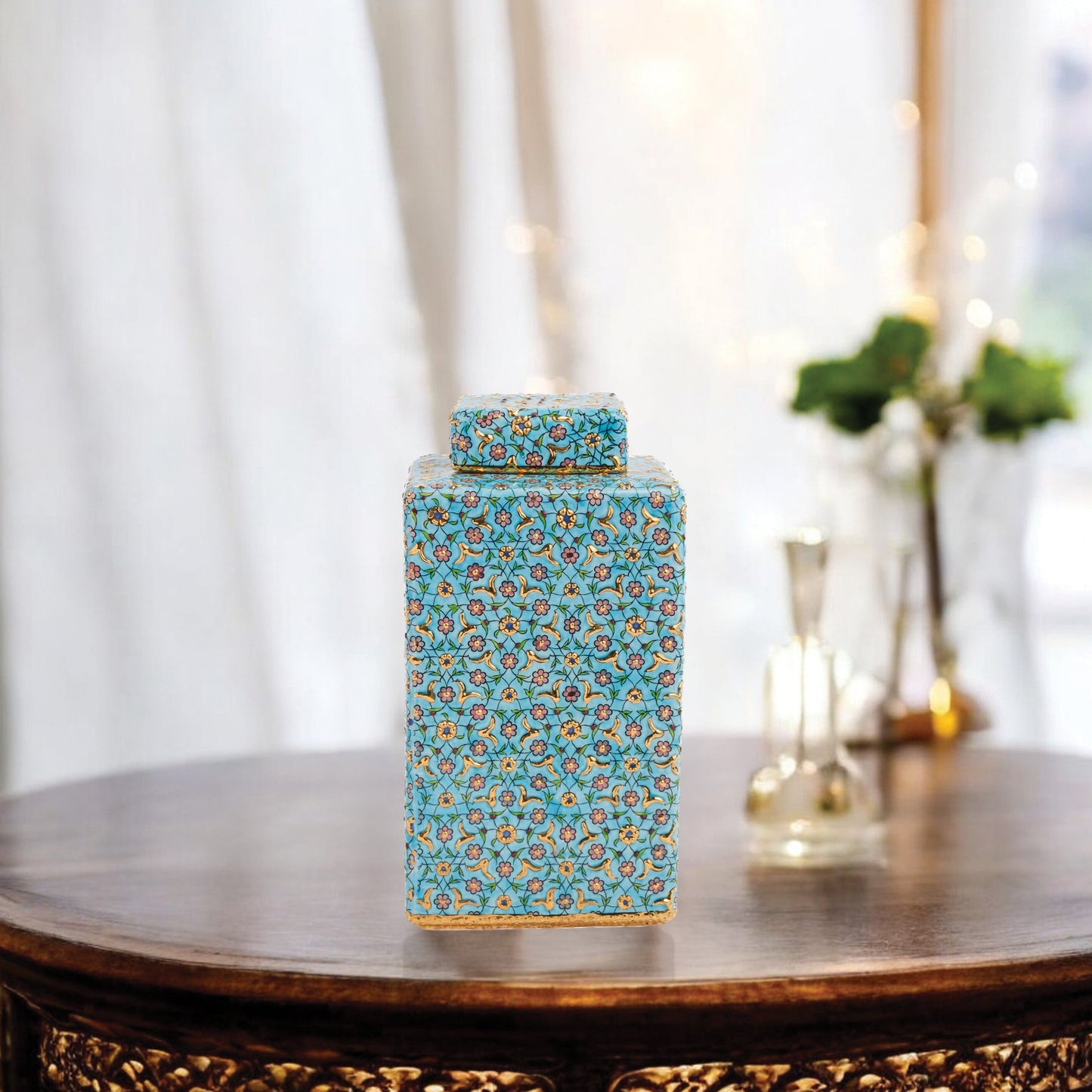 Hand-painted Golden Blossom ceramic jar with turquoise base and gold floral motifs. Square lidded design, artisan-made, perfect for décor, tea, or gifts.