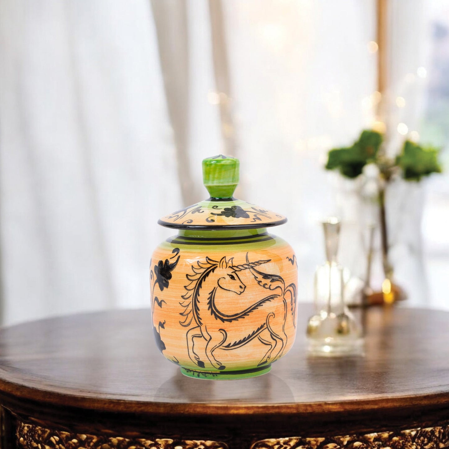 Hand-painted Unicorn Dance ceramic jar with whimsical black unicorn motif on orange & green. Lidded artisan jar, perfect for honey, ginger, spices, or décor.