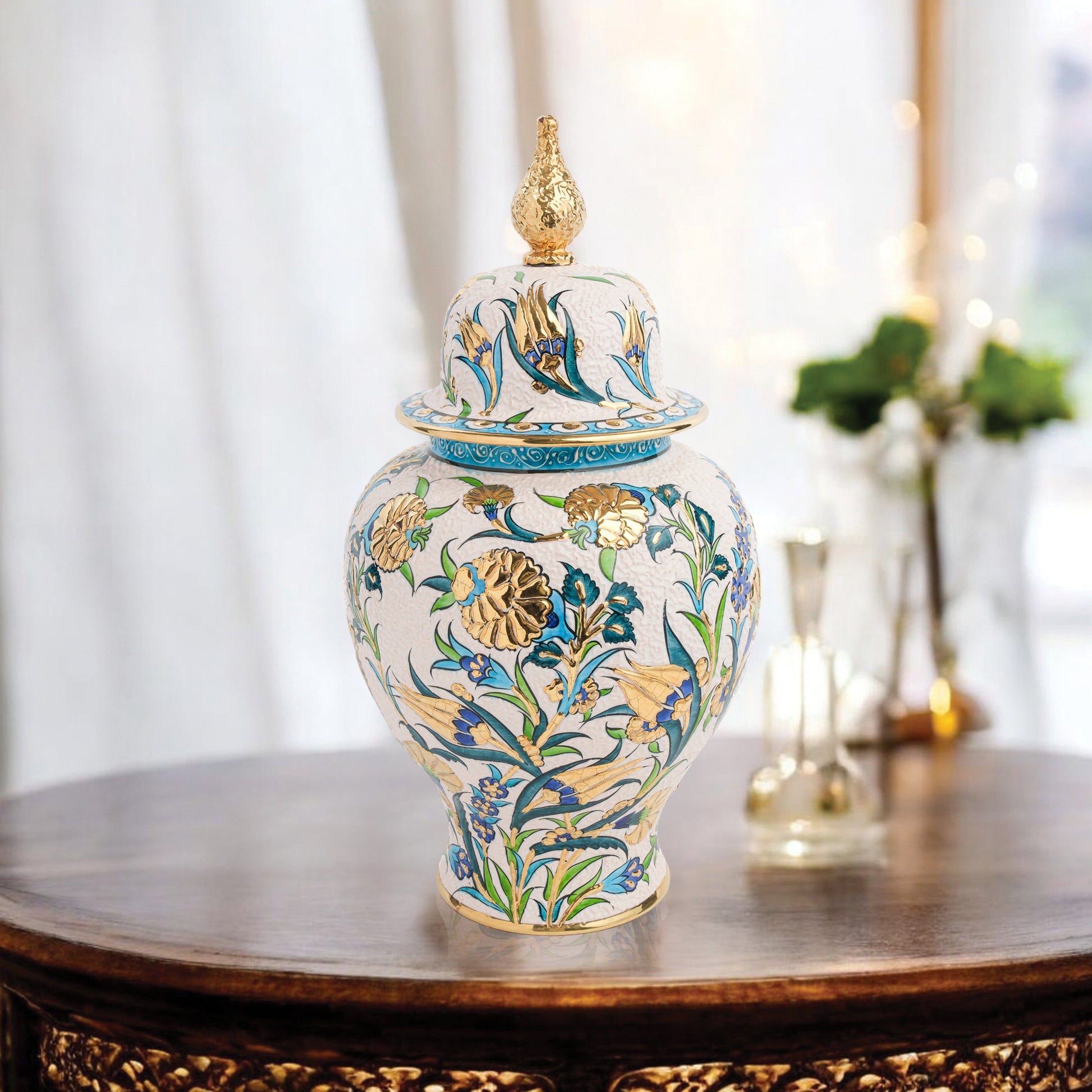 Hand-painted Golden Bloom ceramic jar with blue tulips, green leaves & gold accents. Finished with sculpted golden finial, artisan-made, perfect décor or gift.