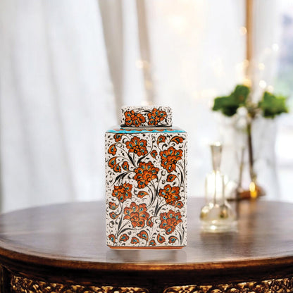 Hand-painted Terracotta Bloom ceramic jar with vivid orange floral motifs. Square lidded design, artisan-crafted, perfect for tea, spices, décor, or gifts.