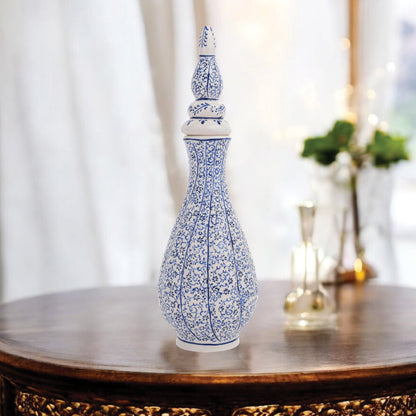 Hand-painted Iznik Nightingale’s Eye ceramic vase with lid, featuring blue vine motifs on white. Tall Ottoman-inspired design, perfect for décor or gifting.