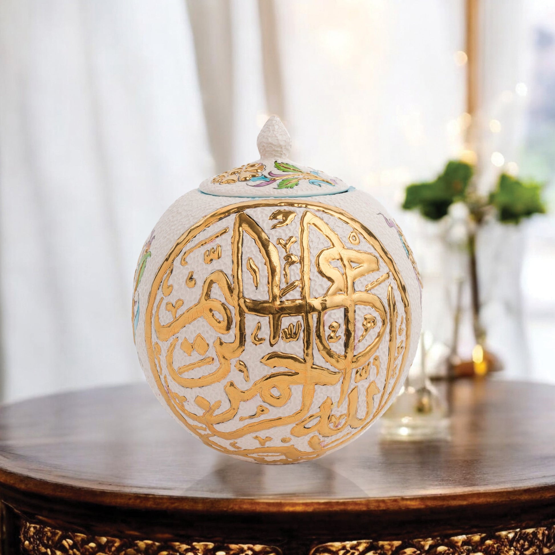 Hand-painted Gold Script globe jar with Arabic calligraphy and turquoise floral motifs. Spherical ceramic design with gold finial, perfect décor or gift.