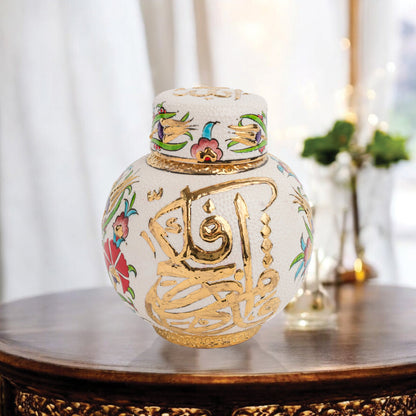 Hand-painted Gold Calligraphy ceramic jar with Ottoman floral motifs & Arabic script. Round melon-shaped design, glossy glazed, perfect décor or gift.