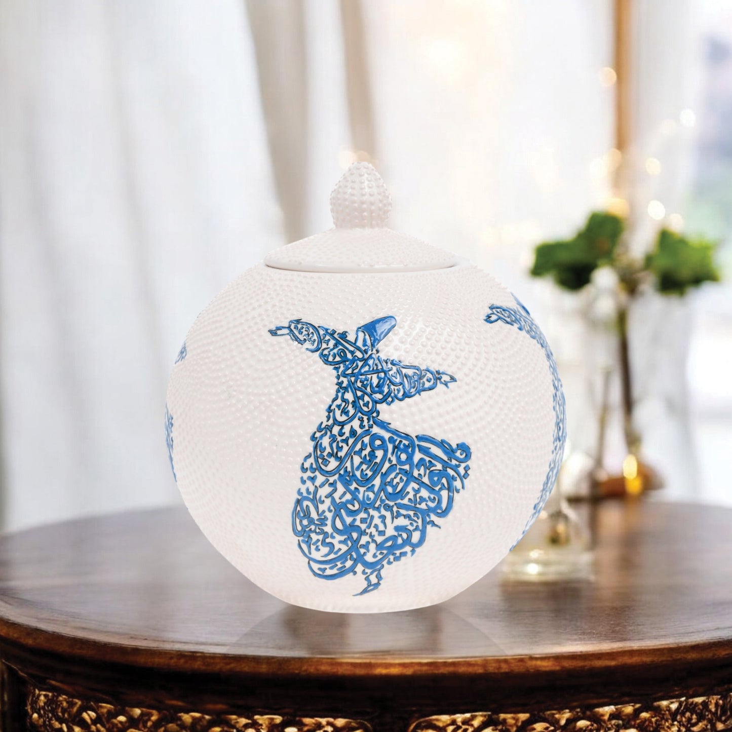 Hand-painted Whirling Dervish globe jar with Arabic calligraphy design. Available in blue or red, this ceramic round jar is perfect for spiritual décor or gifts.