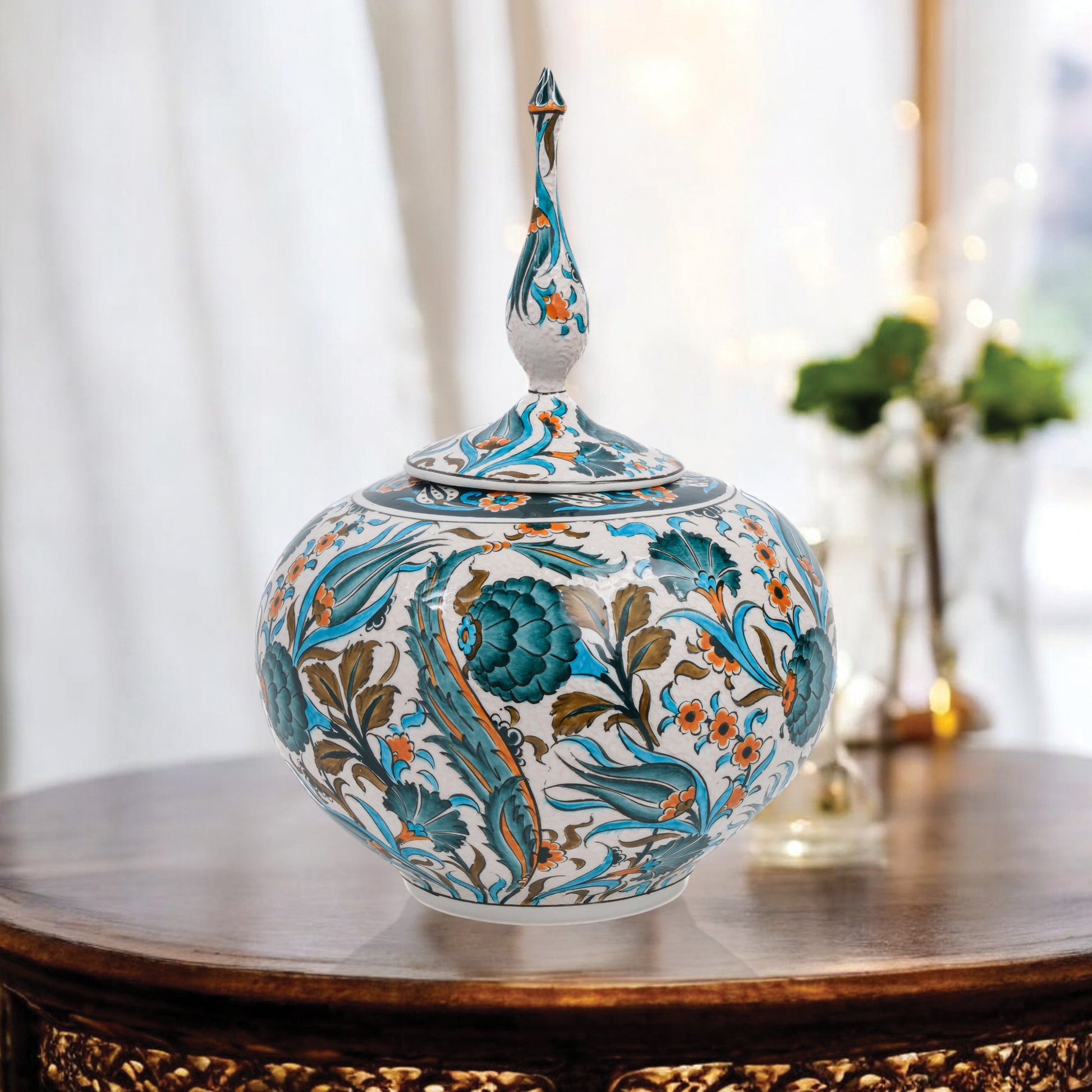 Hand-painted Iznik Bloom globe jar with teal blooms, tulips & vines on white. Bulbous Ottoman-inspired ceramic jar with finial lid, perfect décor or gift.