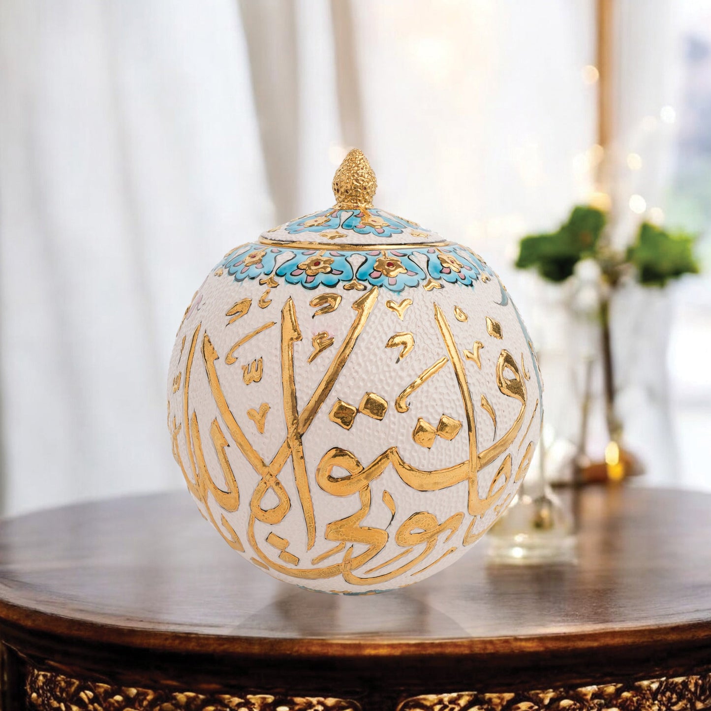 Hand-painted Gold Script globe jar with Arabic calligraphy in gold and turquoise floral trim. Spherical ceramic jar with gilded finial, perfect décor or gift.