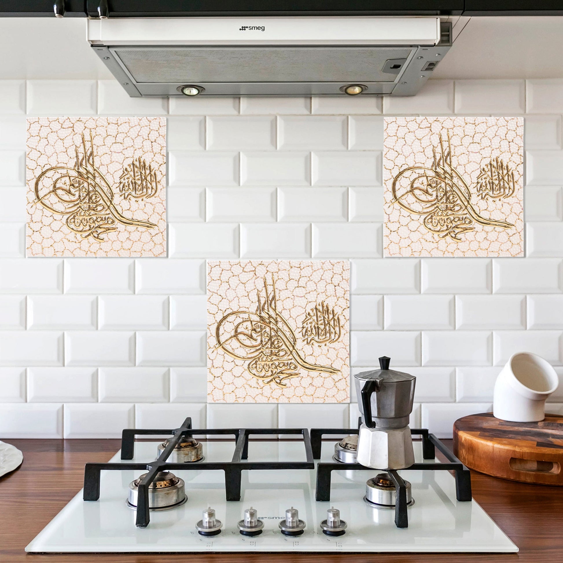 Decorative ceramic tiles with Arabic calligraphy above a stove in a kitchen.
