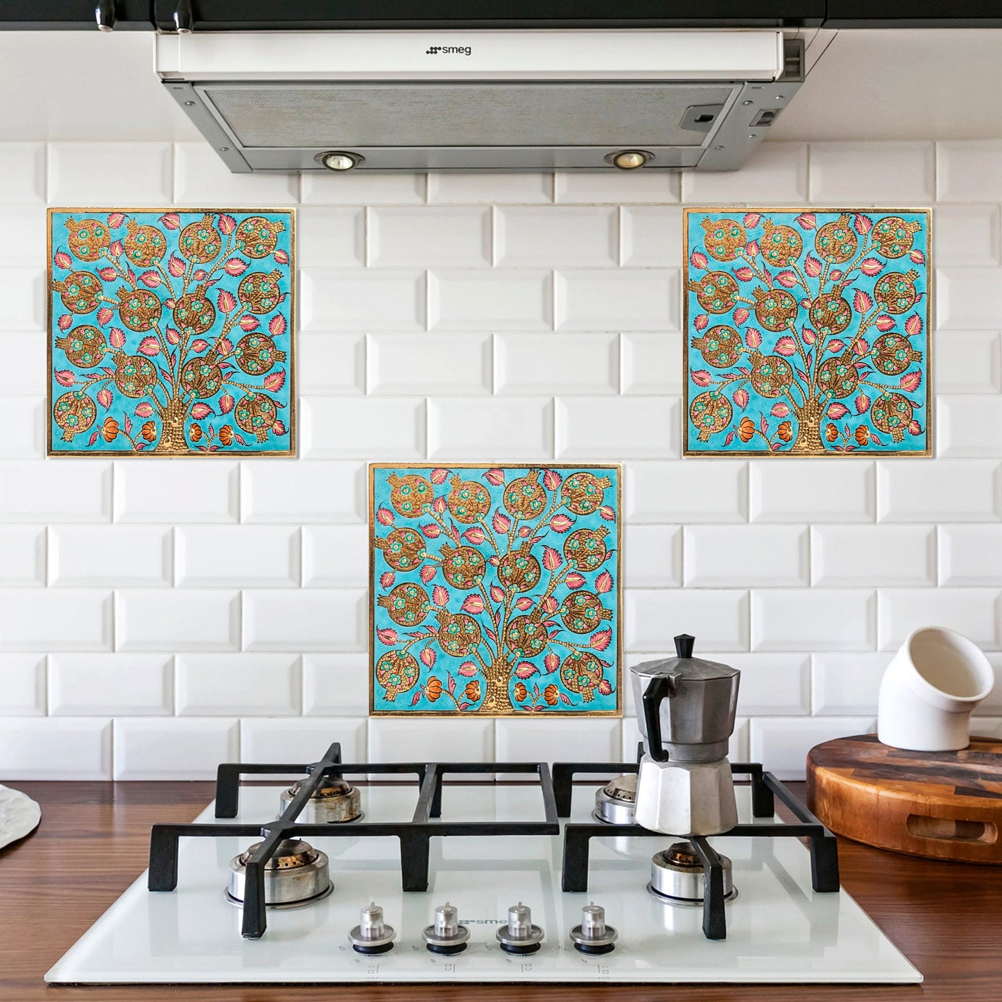 Decorative turquoise and gold ceramic tiles above a stove in a kitchen.