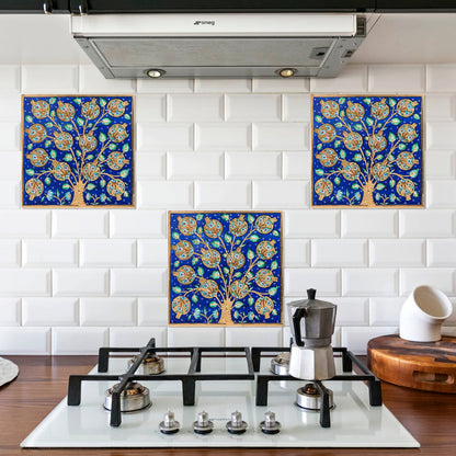 Decorative blue tree-of-life ceramic tiles on a white tiled kitchen backsplash.