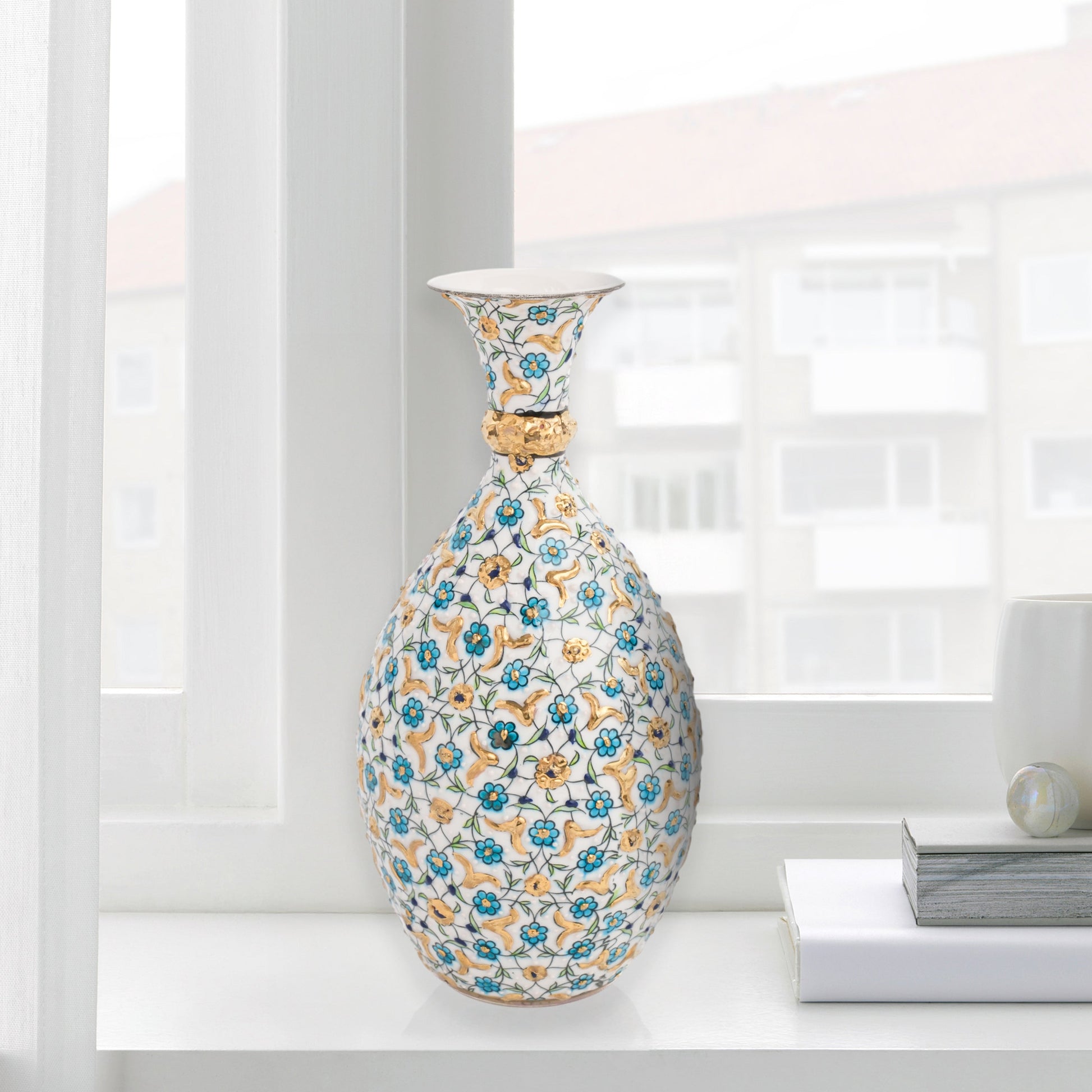 Hand-painted ceramic decorative bottle with turquoise and gold floral motifs on ivory. Glossy artisan vase, elegant décor accent, perfect for gifting.
