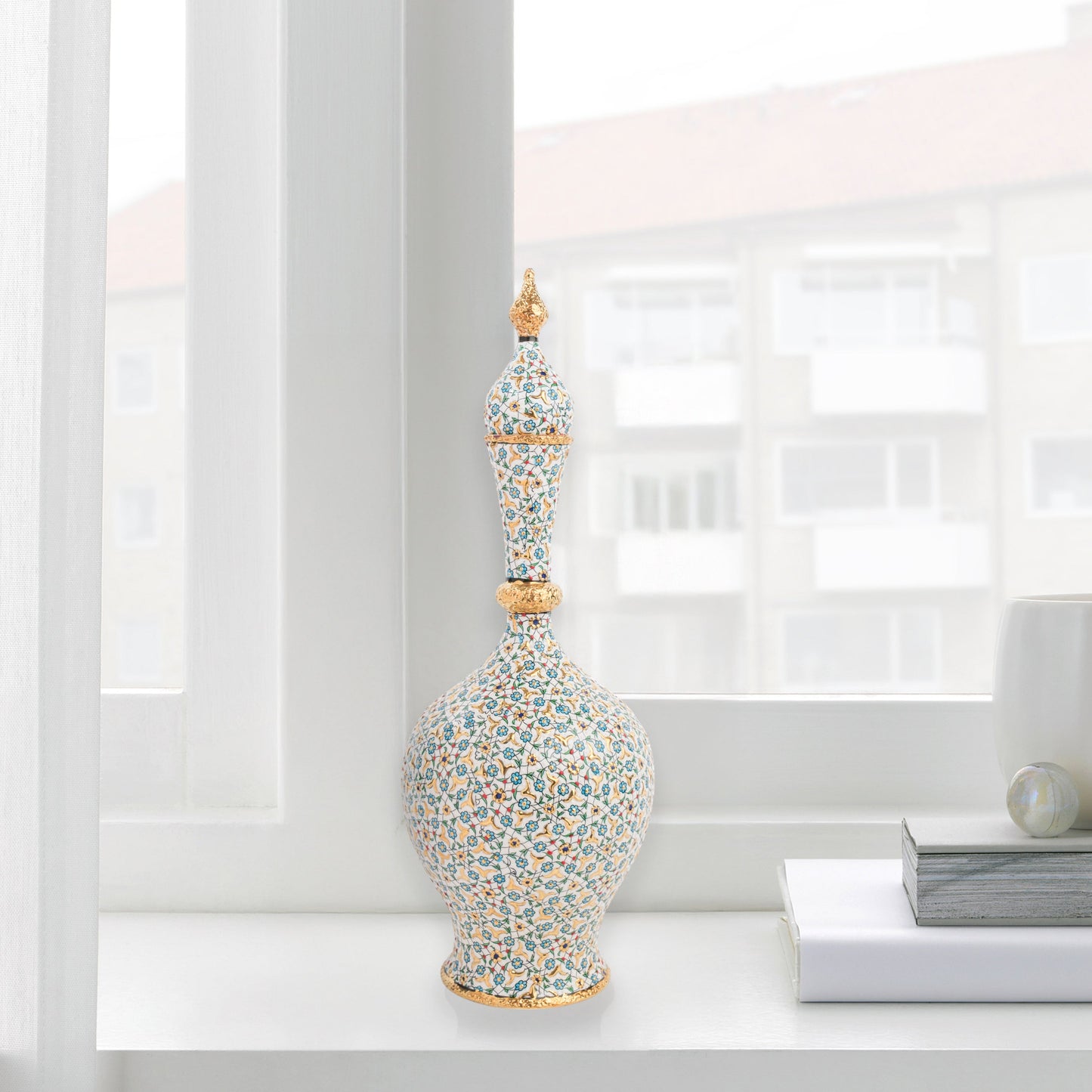 Hand-painted ceramic decorative bottle with turquoise floral motifs and golden details. Minaret-inspired shape with spire lid, perfect for décor or gifting.