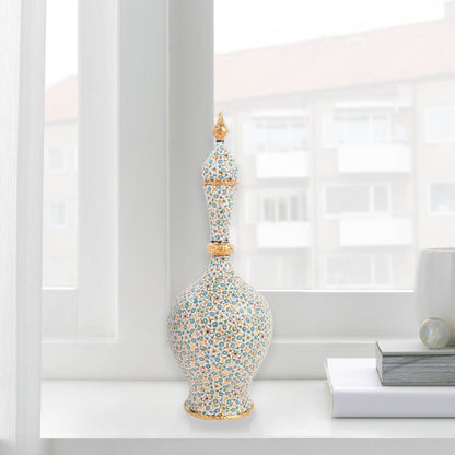Hand-painted ceramic decorative bottle with turquoise floral motifs and golden details. Minaret-inspired shape with spire lid, perfect for décor or gifting.