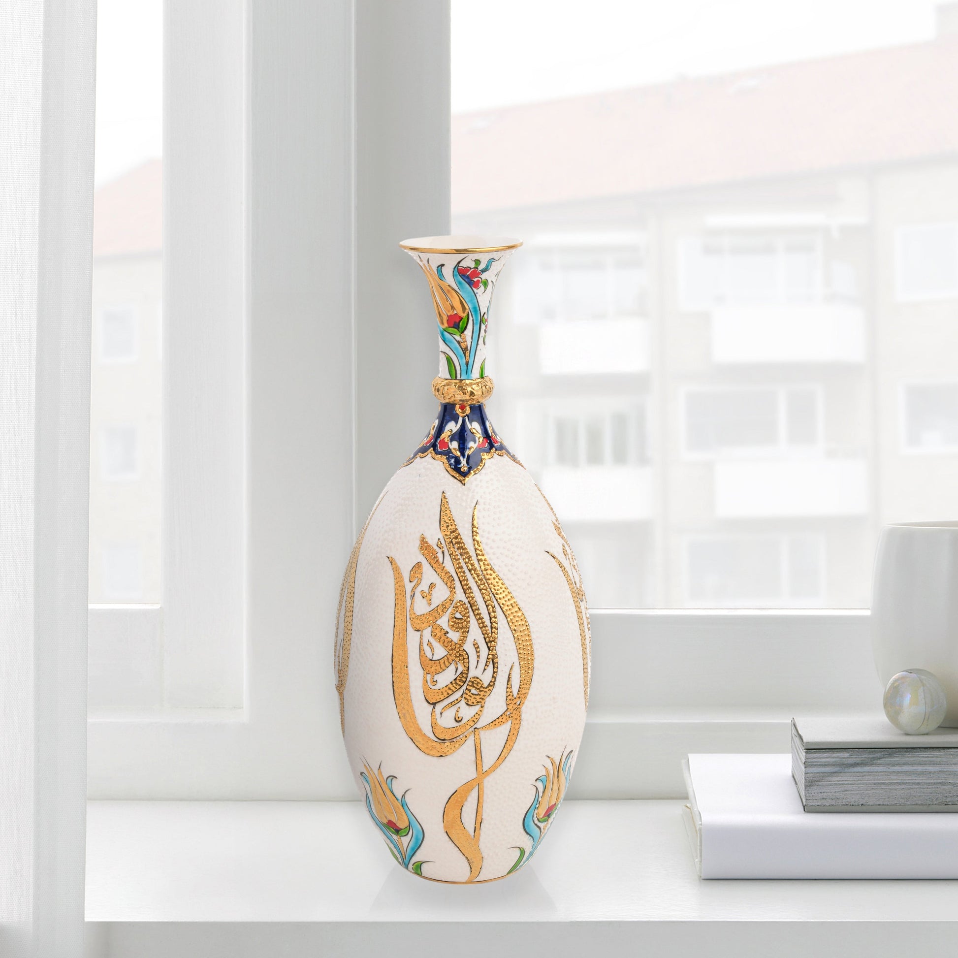 Hand-painted ceramic decorative bottle with golden Arabic calligraphy on ivory, accented with floral motifs. Glossy artisan vase, perfect for décor or gifts.