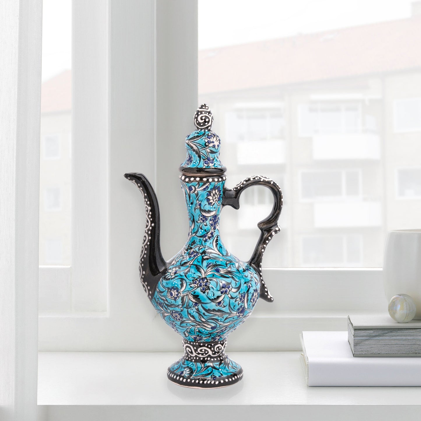 Hand-painted turquoise Ottoman-style ceramic ewer with floral motifs, curved spout & sculptural handle. Decorative artisan piece, perfect décor or gift.