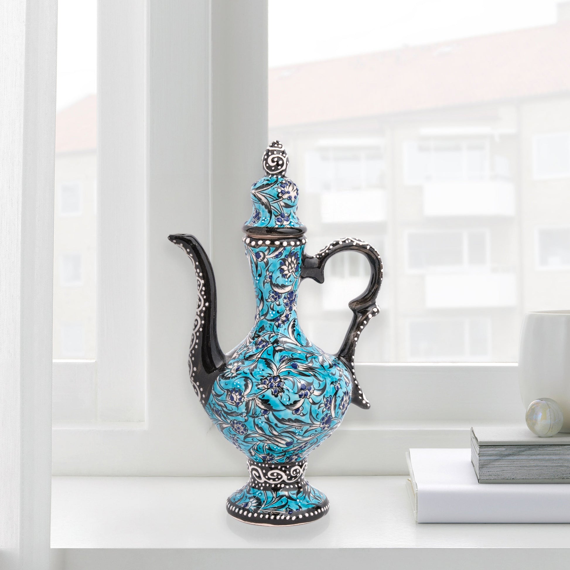 Hand-painted turquoise Ottoman-style ceramic ewer with floral motifs, curved spout & sculptural handle. Decorative artisan piece, perfect décor or gift.