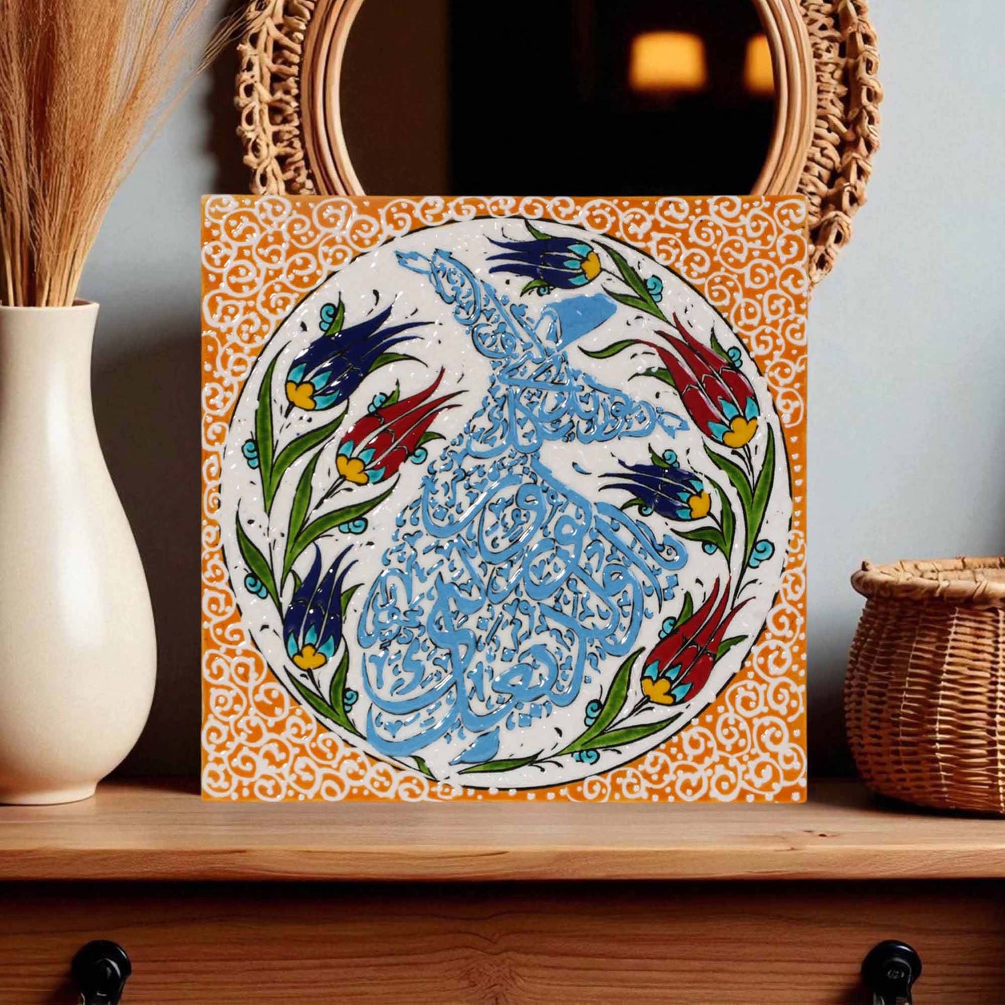 Decorative ceramic wall tile with floral and calligraphic design on a wooden shelf.