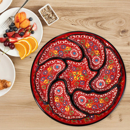 Decorative red snack serving tray set with intricate patterns on a wooden table with breakfast items.
