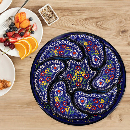 Decorative snack serving tray set with colorful paisley design on a wooden table with breakfast items.