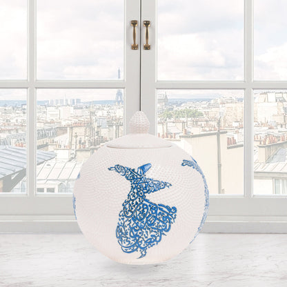 Hand-painted Whirling Dervish globe jar with Arabic calligraphy design. Available in blue or red, this ceramic round jar is perfect for spiritual décor or gifts.