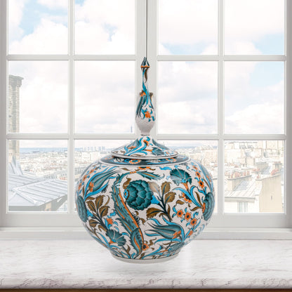 Hand-painted Iznik Bloom globe jar with teal blooms, tulips & vines on white. Bulbous Ottoman-inspired ceramic jar with finial lid, perfect décor or gift.