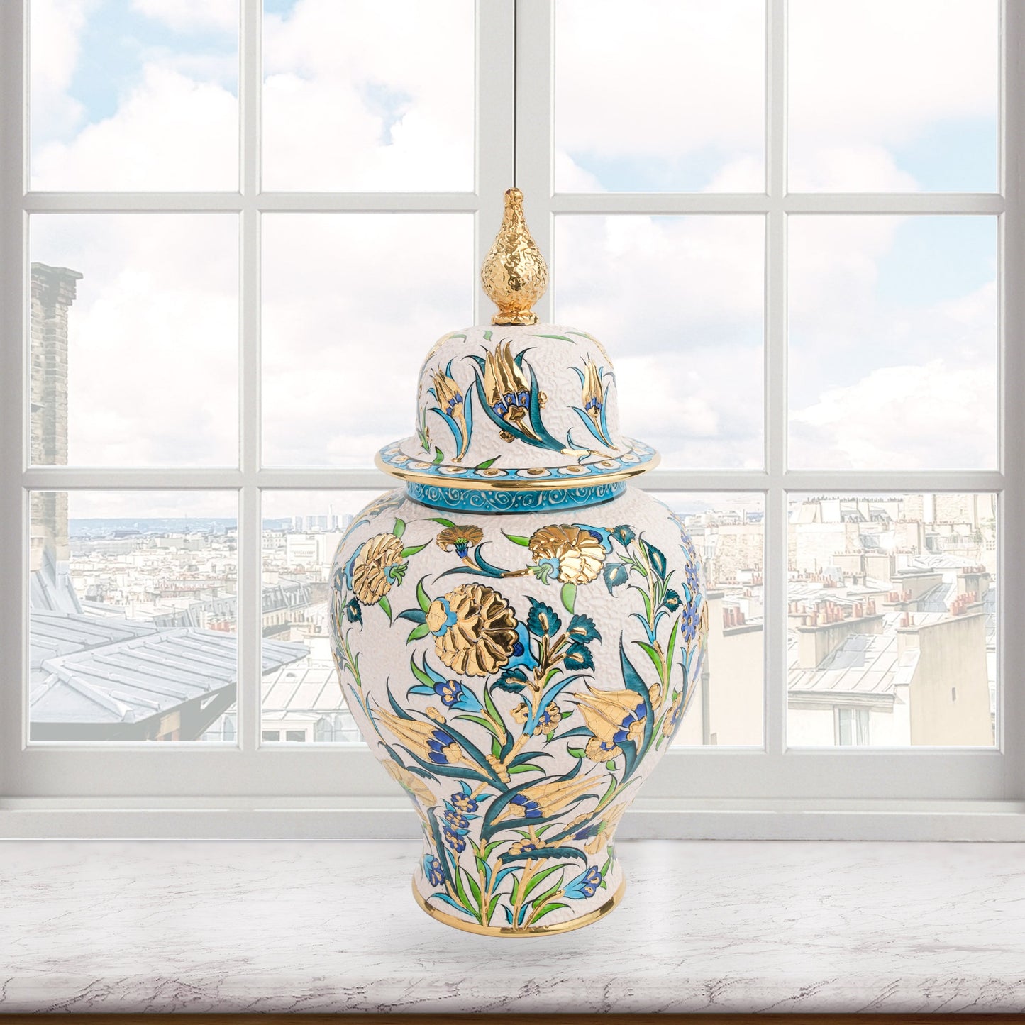 Hand-painted Golden Bloom ceramic jar with blue tulips, green leaves & gold accents. Finished with sculpted golden finial, artisan-made, perfect décor or gift.