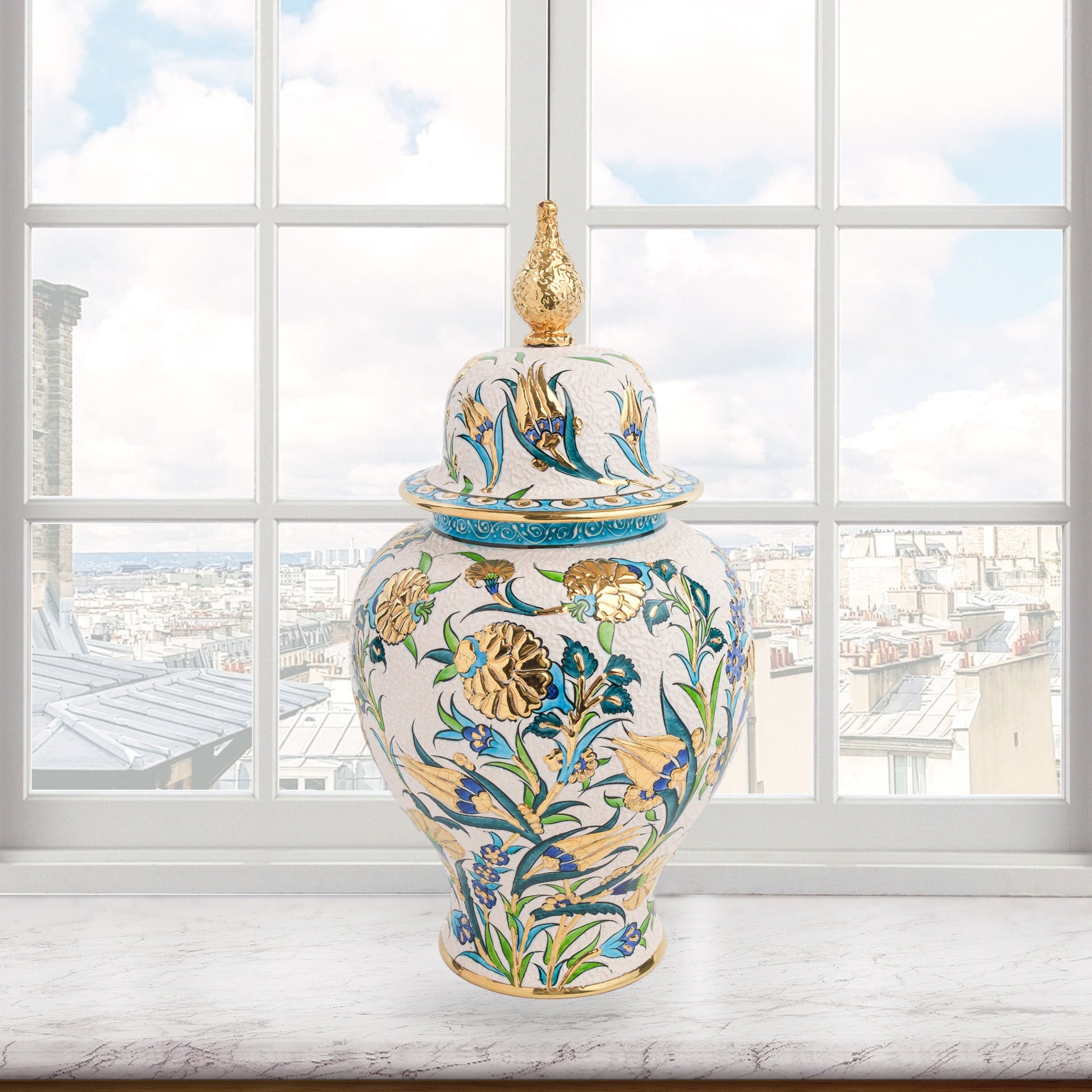 Hand-painted Golden Bloom ceramic jar with blue tulips, green leaves & gold accents. Finished with sculpted golden finial, artisan-made, perfect décor or gift.
