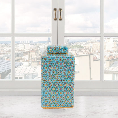 Hand-painted Golden Blossom ceramic jar with turquoise base and gold floral motifs. Square lidded design, artisan-made, perfect for décor, tea, or gifts.