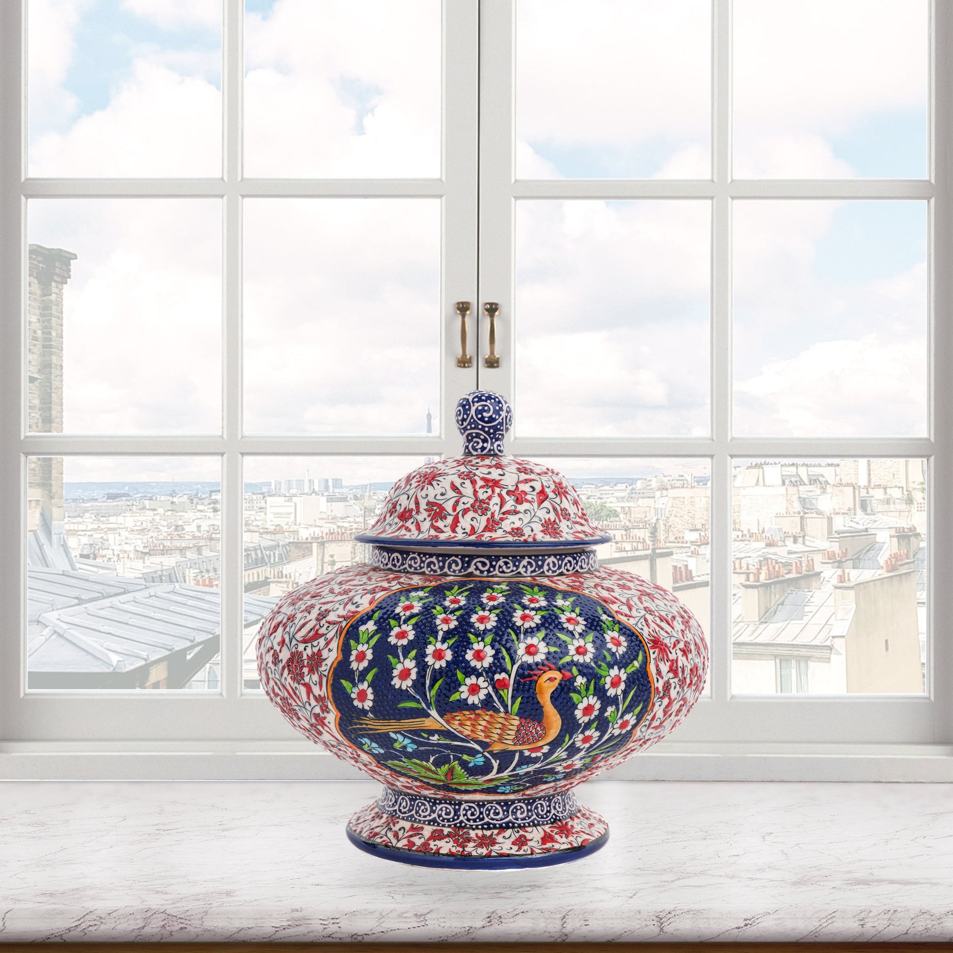 Hand-painted Songbird Bloom ceramic jar with bird and daisy motifs in navy, red & green. Wide artisan jar, glossy glazed, perfect décor accent or gift.