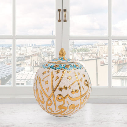 Hand-painted Gold Script globe jar with Arabic calligraphy in gold and turquoise floral trim. Spherical ceramic jar with gilded finial, perfect décor or gift.
