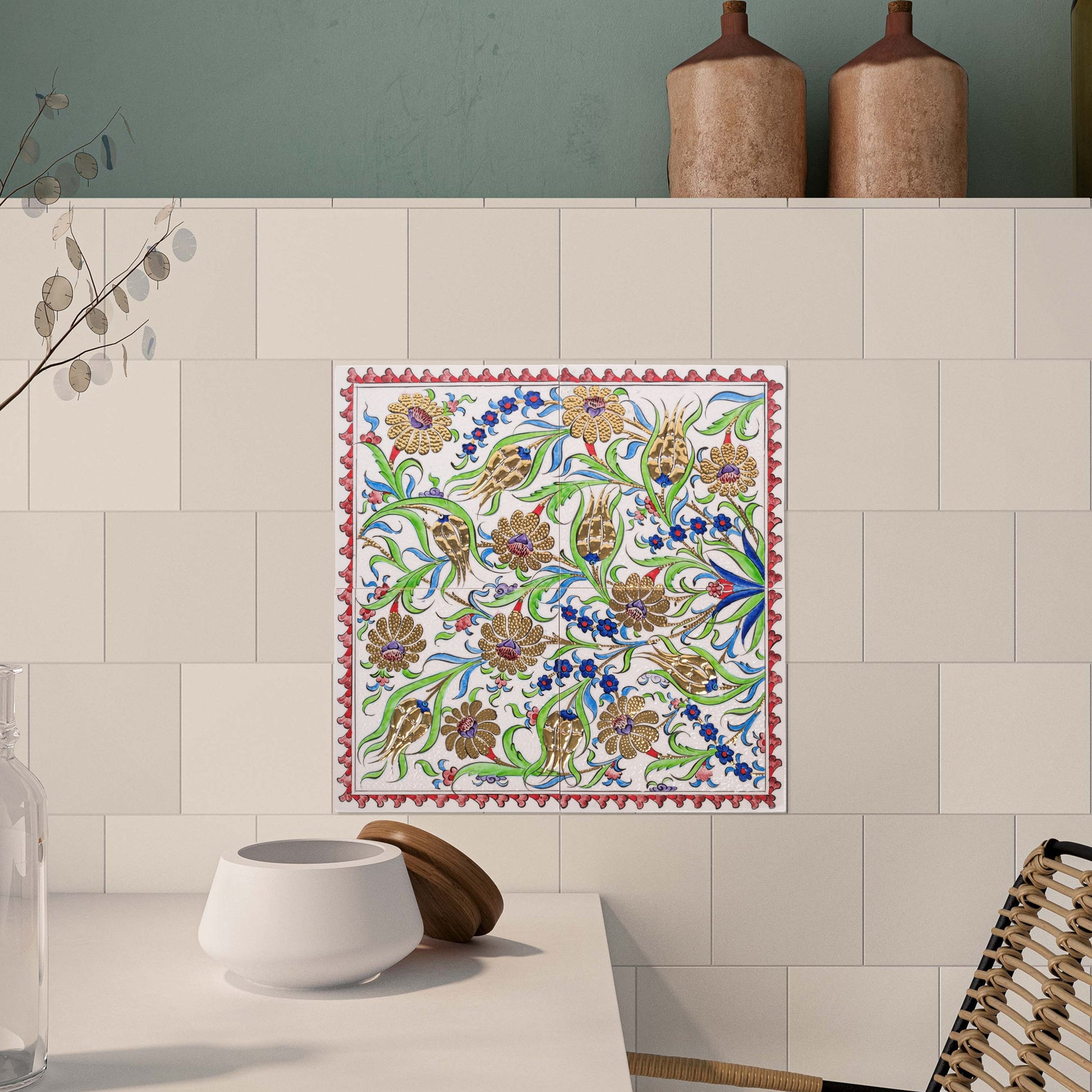 Decorative ceramic tile with floral pattern on a kitchen wall.