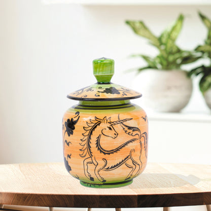 Hand-painted Unicorn Dance ceramic jar with whimsical black unicorn motif on orange & green. Lidded artisan jar, perfect for honey, ginger, spices, or décor.