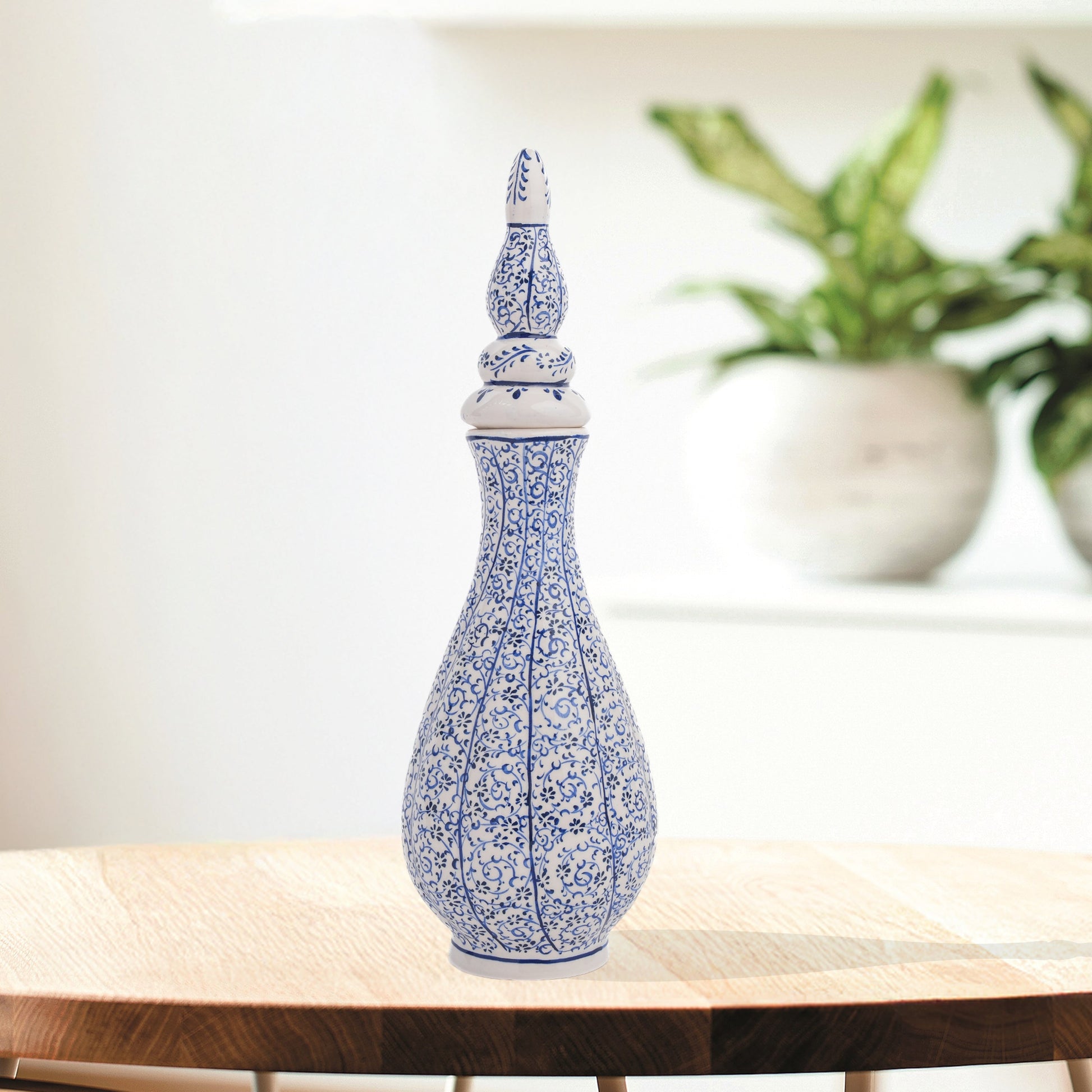 Hand-painted Iznik Nightingale’s Eye ceramic vase with lid, featuring blue vine motifs on white. Tall Ottoman-inspired design, perfect for décor or gifting.