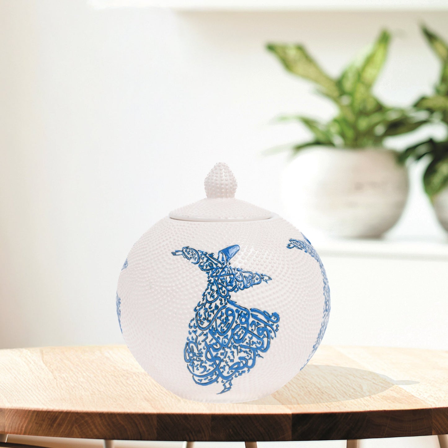 Hand-painted Whirling Dervish globe jar with Arabic calligraphy design. Available in blue or red, this ceramic round jar is perfect for spiritual décor or gifts.
