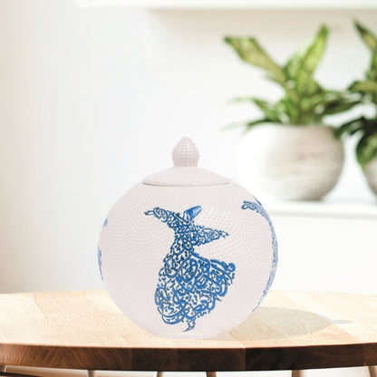 Hand-painted Whirling Dervish globe jar with Arabic calligraphy design. Available in blue or red, this ceramic round jar is perfect for spiritual décor or gifts.