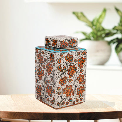 Hand-painted Terracotta Bloom ceramic jar with vivid orange floral motifs. Square lidded design, artisan-crafted, perfect for tea, spices, décor, or gifts.