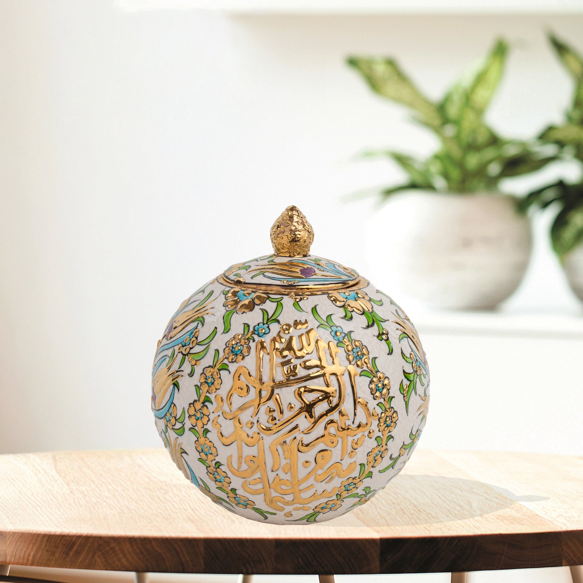 Hand-painted Floral Script globe jar with golden Arabic calligraphy and turquoise floral motifs. Spherical ceramic design, artisan-made, perfect décor or gift.
