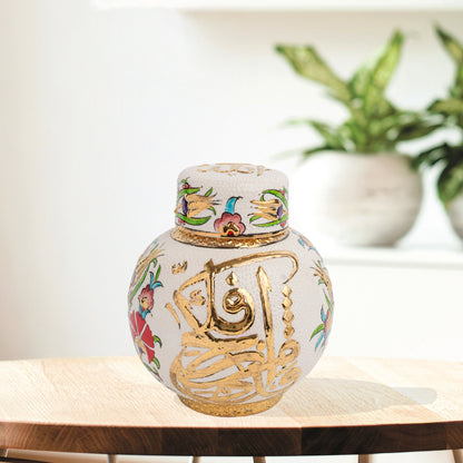 Hand-painted Gold Calligraphy ceramic jar with Ottoman floral motifs & Arabic script. Round melon-shaped design, glossy glazed, perfect décor or gift.